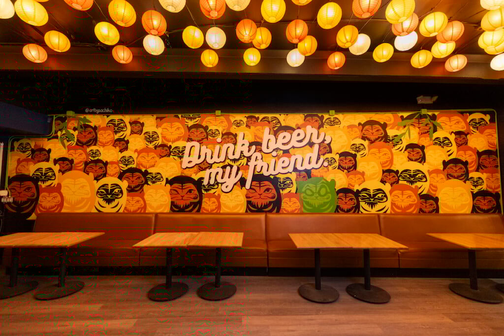 bright mural under colorful lanterns
