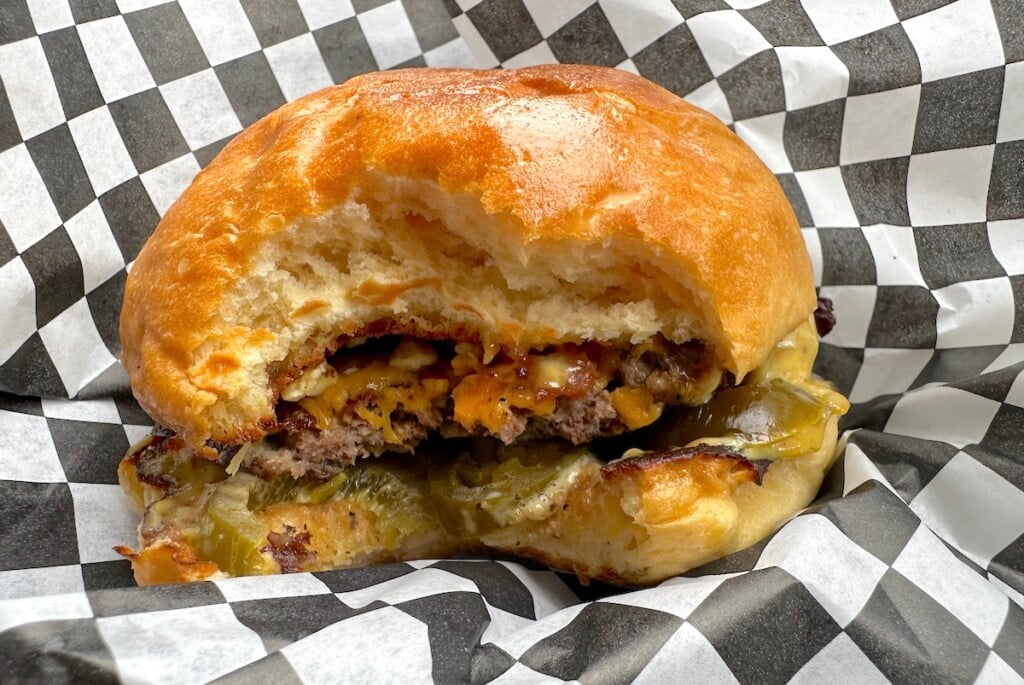 juicy wagyu burger with a bite taken out