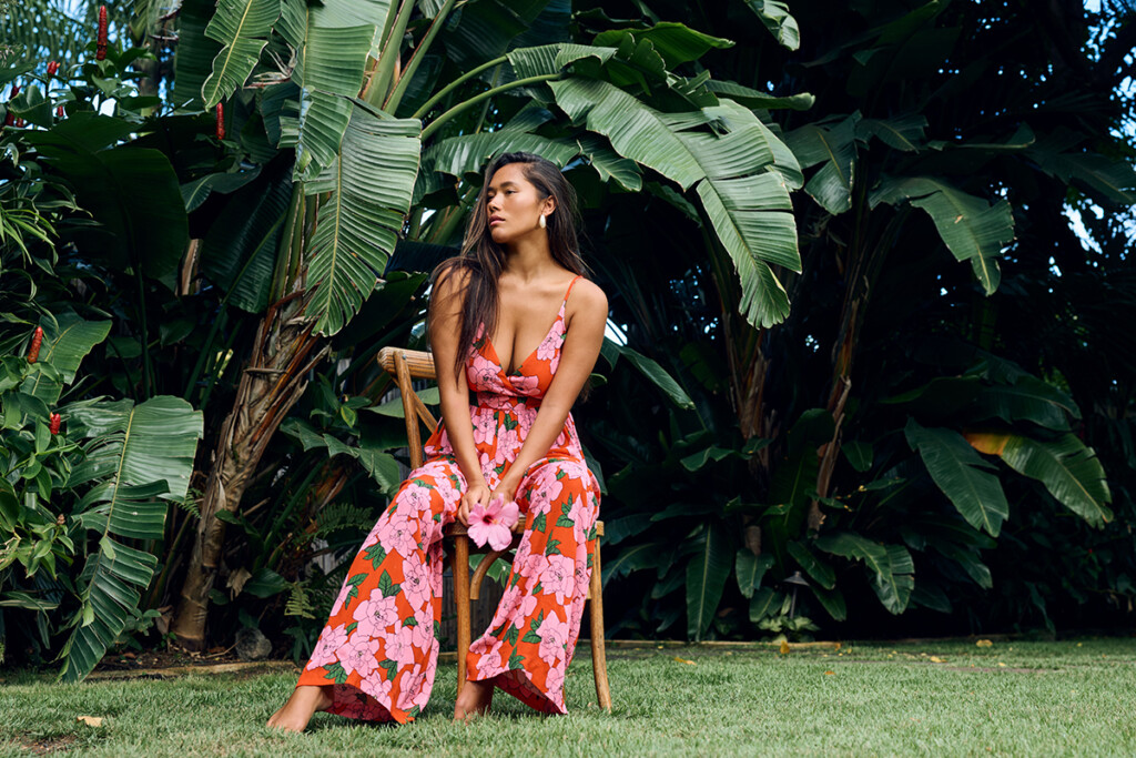 woman in garden wearing red floral jumper
