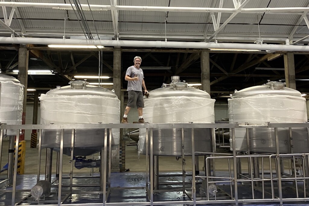 geoff seideman atop tanks at Honolulu Beerworks Kapalama Facility