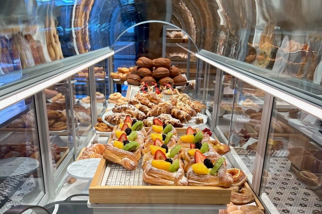 assortment of tarts and pastries inside glass case