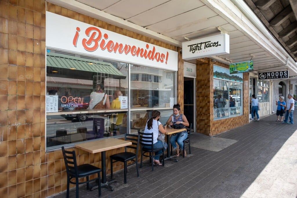 women eat at sidewalk table outside Tight Tacos
