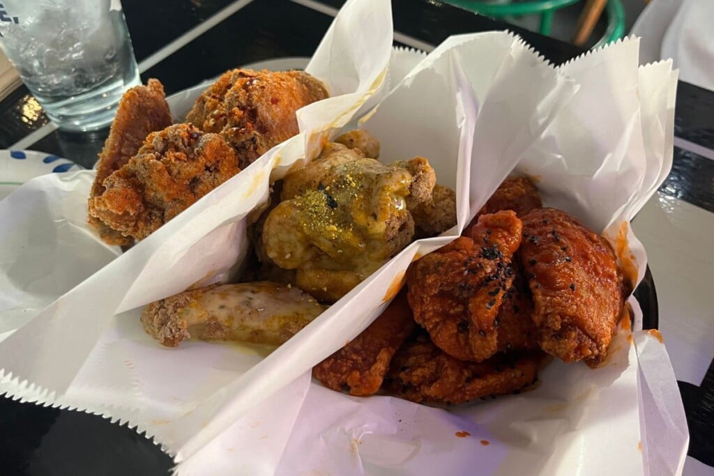 three kinds of chicken wings nestled in white paper